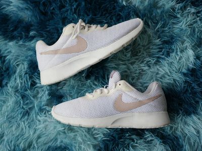 A pair of blue sneakers on a dark textured background